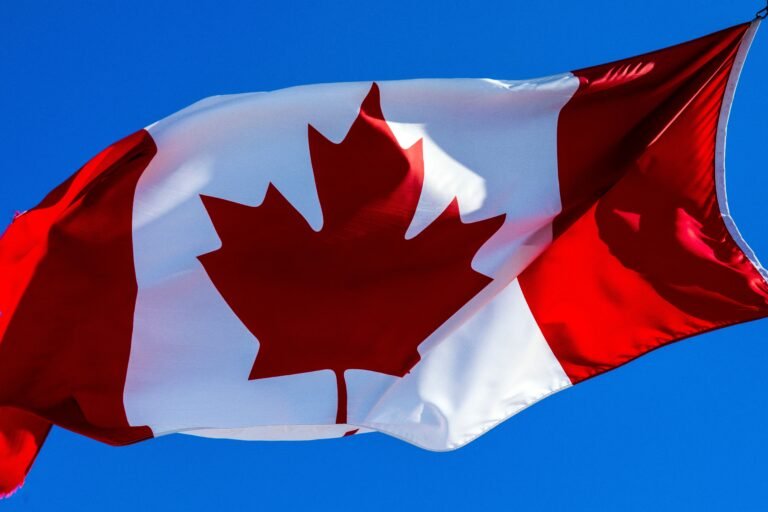 Canada immigration 2026 concept showing Canadian flag, skyline, and visa application documents representing new immigration policies and opportunities